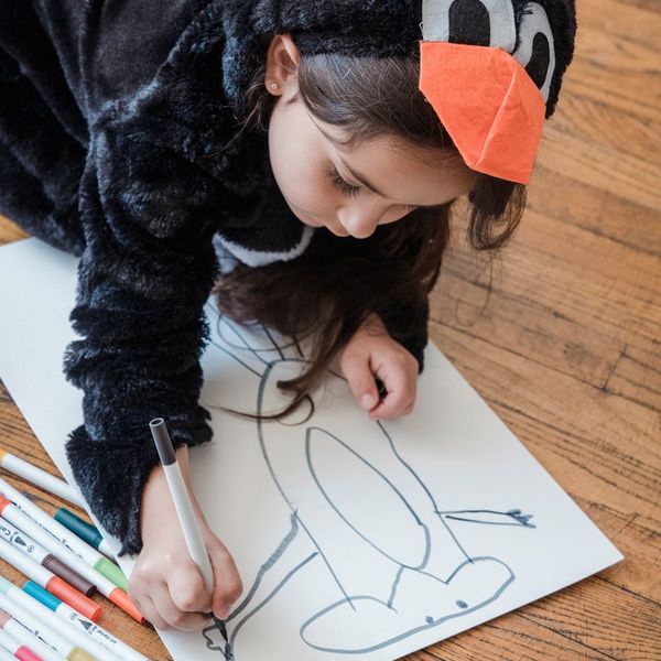 Children drawing and coloring on the floor after a yoga session.